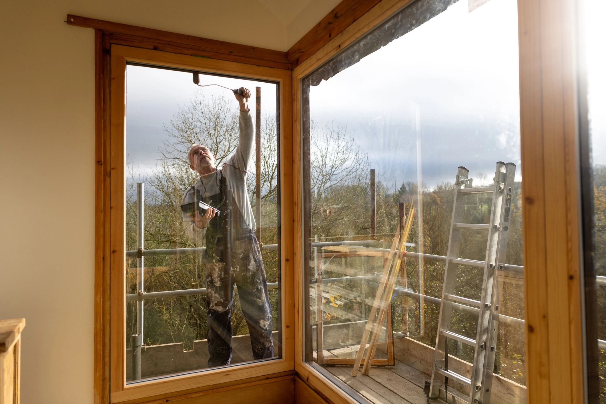 Exterior house painting in progress on a residential home